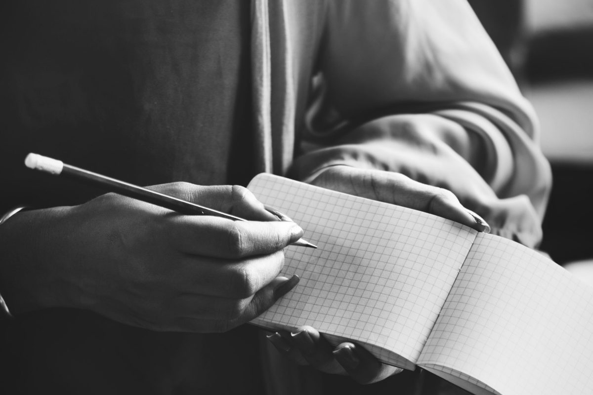 Woman writing down notes in a notebook